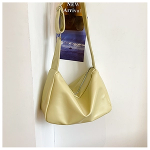 Detail of light green PU hobo bag with adjustable wide strap and silver metal buckle