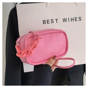 Detail showing the pink mini handbag with stylish plastic chain and wristlet strap
