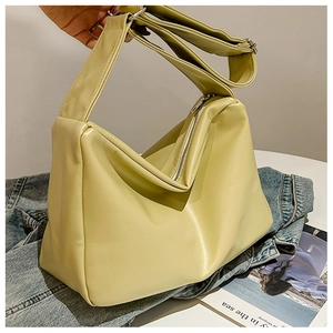 Detail of soft pale yellow PU leather tote with adjustable wide strap and zipper closure