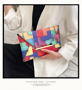 Close-up of colorful geometric pattern clutch with a golden metallic bar closure