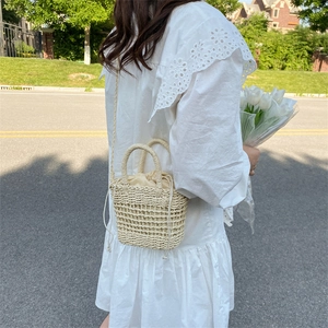Handmade woven straw bucket bag with drawstring liner and shoulder strap for beach