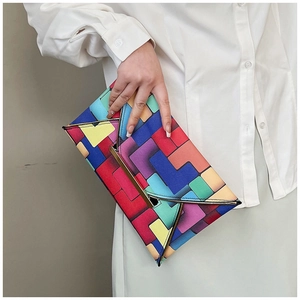 Close-up of colorful geometric pixel pattern envelope clutch with gold metal trim