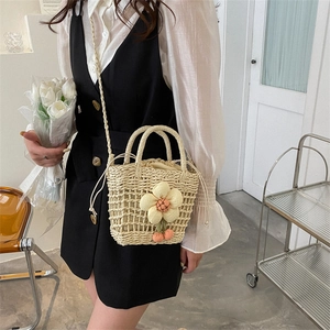 Mini hollow straw bucket bag with floral cherry decor for summer beach vacations