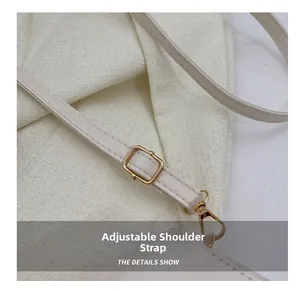 Detail view of adjustable white PU leather shoulder strap with gold metal buckle