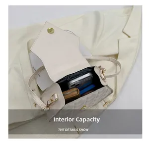 Internal capacity of beige quilted crossbody bag showing space for phone and wallet