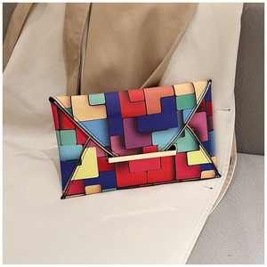 Detail of colorful geometric envelope clutch featuring a sleek gold metal buckle closure
