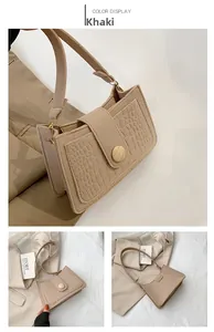 Detail view of khaki felt shoulder bag with crocodile texture panel and large button closure