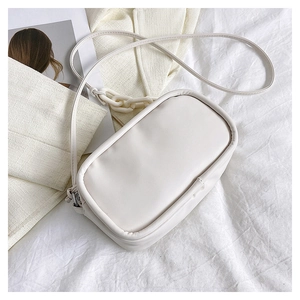 White minimalist crossbody bag featuring a thick decorative plastic chain and slim strap