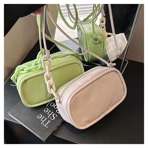 Chic small crossbody bags with chunky chain detail in neon green and cream beige