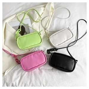 Detailed view of four colorful quilted PU leather crossbody bags with acrylic chains
