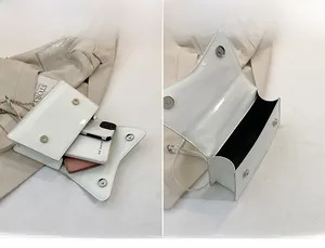 Detail showing the internal capacity and storage space of the white patent leather bag