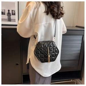 Detailed back view of a black geometric crossbody bag with quilted pattern and gold tassel