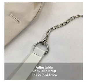 Detail of adjustable white leather strap with silver metal chain and lobster clasp