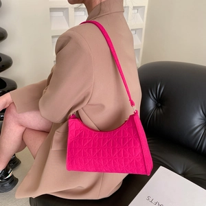 Magenta underarm baguette bag with heart-shaped velvet quilting and fabric strap