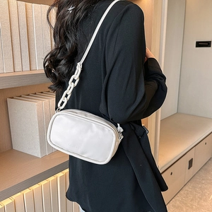 Chic white leather small square crossbody bag with resin chain strap shown on a model