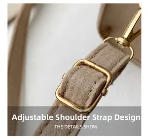 Detail of adjustable khaki felt shoulder strap with polished gold metal hardware buckle