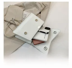 Detail showing the internal storage capacity of the white leather crossbody chain bag