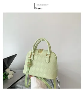 Detail of light green PU leather bag with quilted pattern and golden hardware zipper