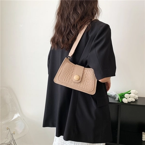 Chic beige underarm bag with crocodile pattern and wooden buckle on a wide shoulder strap