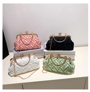 Detail of woven satin texture evening clutches with gold metal hardware in multiple colors