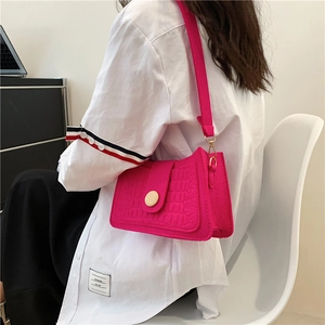 Fuchsia crocodile embossed faux leather underarm bag with circular wood-style buckle