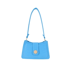 Vibrant blue felt shoulder bag with crocodile texture and wood button detail