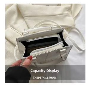 Capacity display of the white crocodile embossed handbag with interior compartments