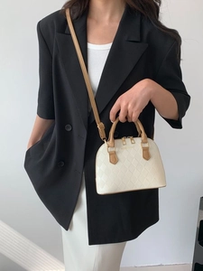 Chic quilted shell bag in cream white PU leather with brown contrast trim and handles
