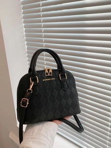 Elegant black quilted shell handbag with gold hardware and removable shoulder strap