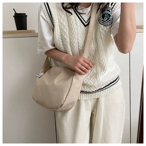 Detail of cream corduroy crossbody bag featuring a soft texture and cute cloud charm