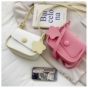 Detail shot of white and pink minimalist PU leather crossbody bags with star charms