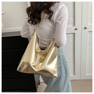 Metallic gold tote bag shown on model highlighting its large capacity and soft PU leather