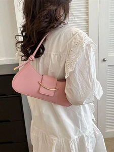 Stylish pink leather crescent shoulder bag with gold buckle and knotted strap detail