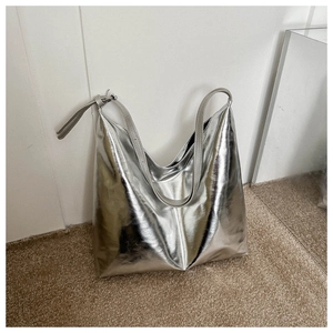 Detail of silver metallic tote bag showing reflective hobo structure and buckle