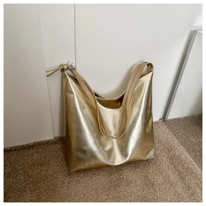 Detailed view of large gold metallic hobo tote bag with mirror finish and spacious interior