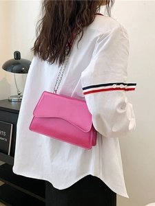 Pink rectangular crossbody bag with wavy flap and silver chain strap for women