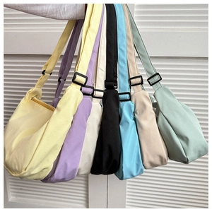 Showcase of seven candy-colored crossbody bags in various pastel hues on white shutters