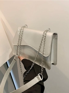 Silver metallic shoulder bag with wavy flap design and chain strap for daily wear