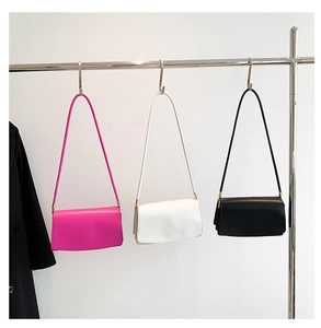 Detailed comparison of minimalist leather underarm bags in fuchsia, white, and black colors