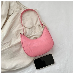 Detailed top view of pink crescent moon bag with crocodile texture and metal zipper
