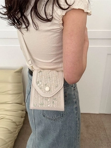 Cream lace woven crossbody bag with green floral embroidery and fine shoulder strap
