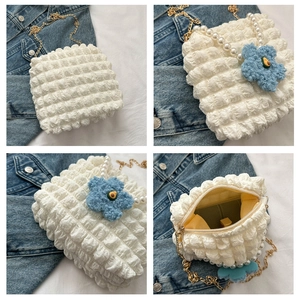 Detail of white bubble texture tote with pearl handle, gold chain and floral charm