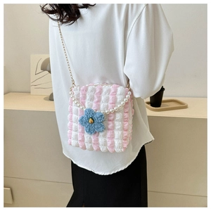Detail of pink bubble ruffle tote with pearl handle and blue plush flower charm