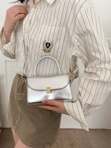 Glossy silver mini crossbody bag with golden metal buckle and top handle for women