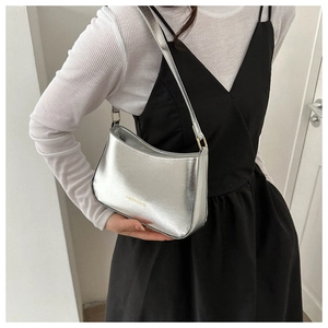 Detail of silver metallic underarm bag showing textured PU leather and fashion gold logo