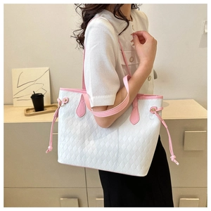 Detail of white quilted tote bag with pink straps and decorative side drawstrings