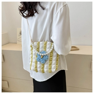 Detail of yellow stripe ruched bag with blue flower, pearl handle and gold chain strap