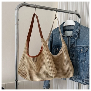 Close-up of woven hollow mesh straw tote bags with leather and ribbon handle details