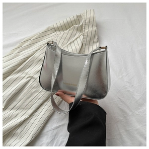 Detail of silver metallic shoulder bag with double straps and fashion text print