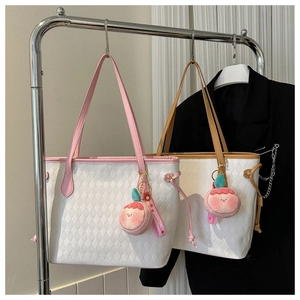 Detail of pink and brown quilted tote bags with peach plush charms on hangers